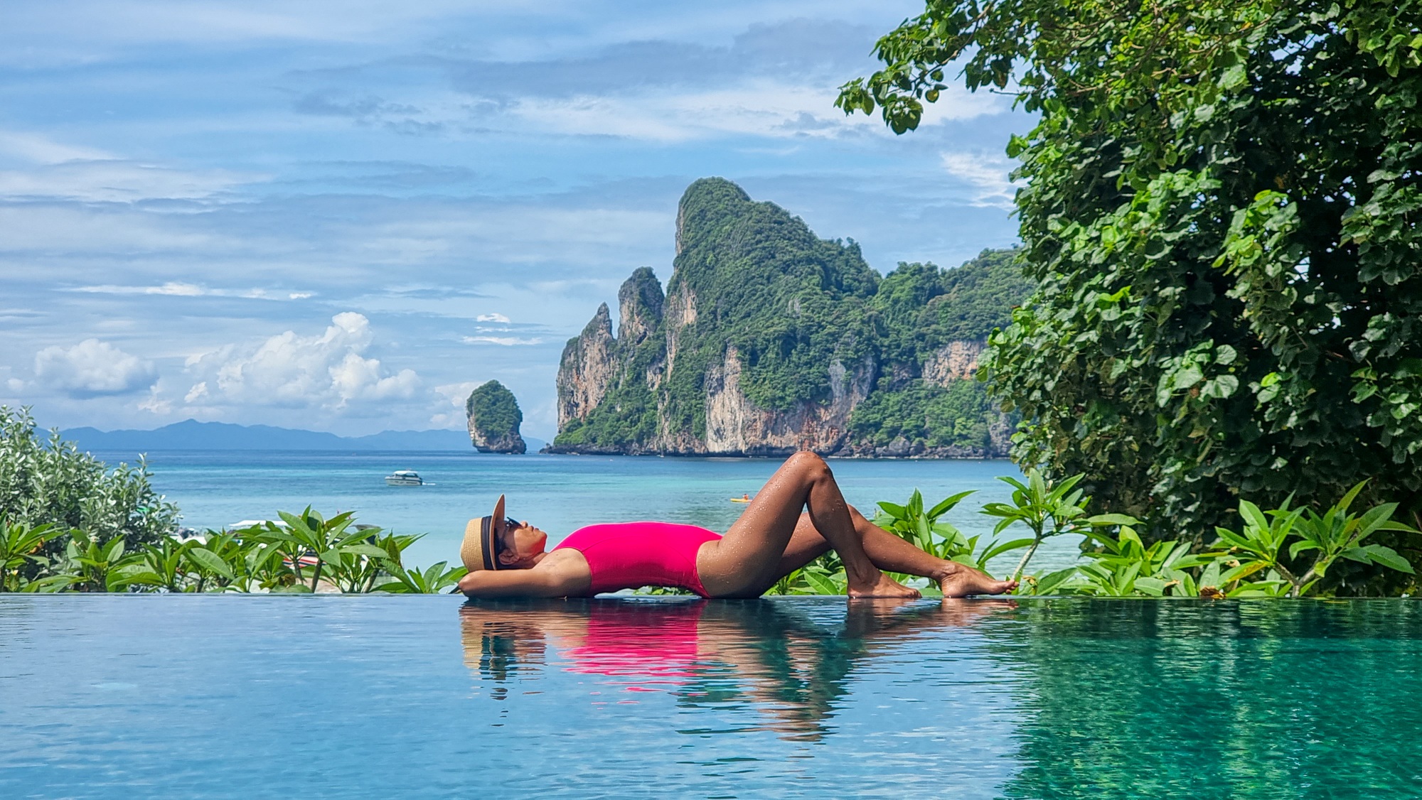 Asian Thai women in badsuit on the edge of an infinity pool at Koh Phi Phi Thailand