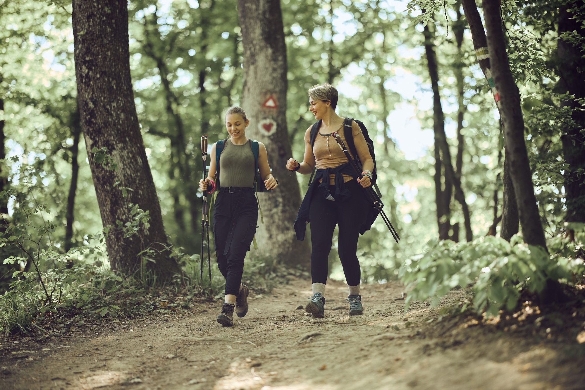 Mother And Daughter Hiking In The Forest